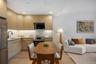 Kitchen with modern cabinets, light brown cabinets, appliances with stainless steel finishes, light wood finished floors, and recessed lighting