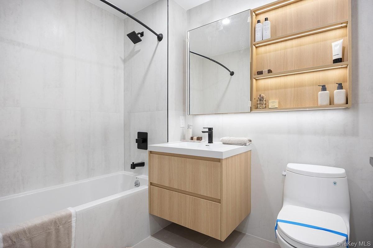 Full bathroom with shower / tub combination and vanity