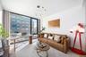 Living area with an office area and a wall of windows