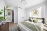 Bedroom with electric panel and light wood-type flooring