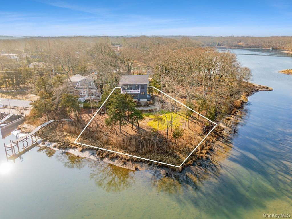 View of property location with property parcel outlined and a nearby body of water