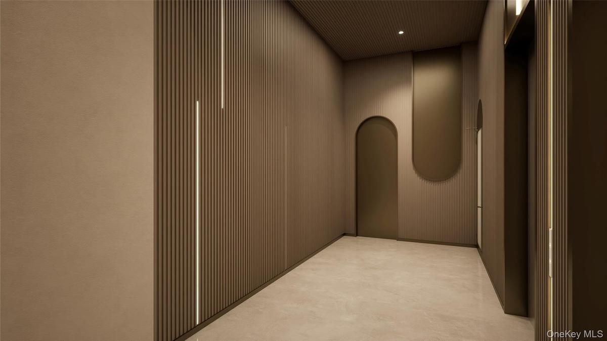 Corridor with elevator, arched walkways, and recessed lighting