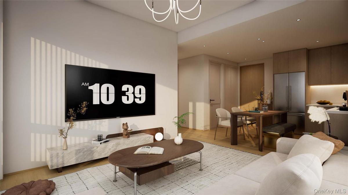 Living area with light wood finished floors and recessed lighting