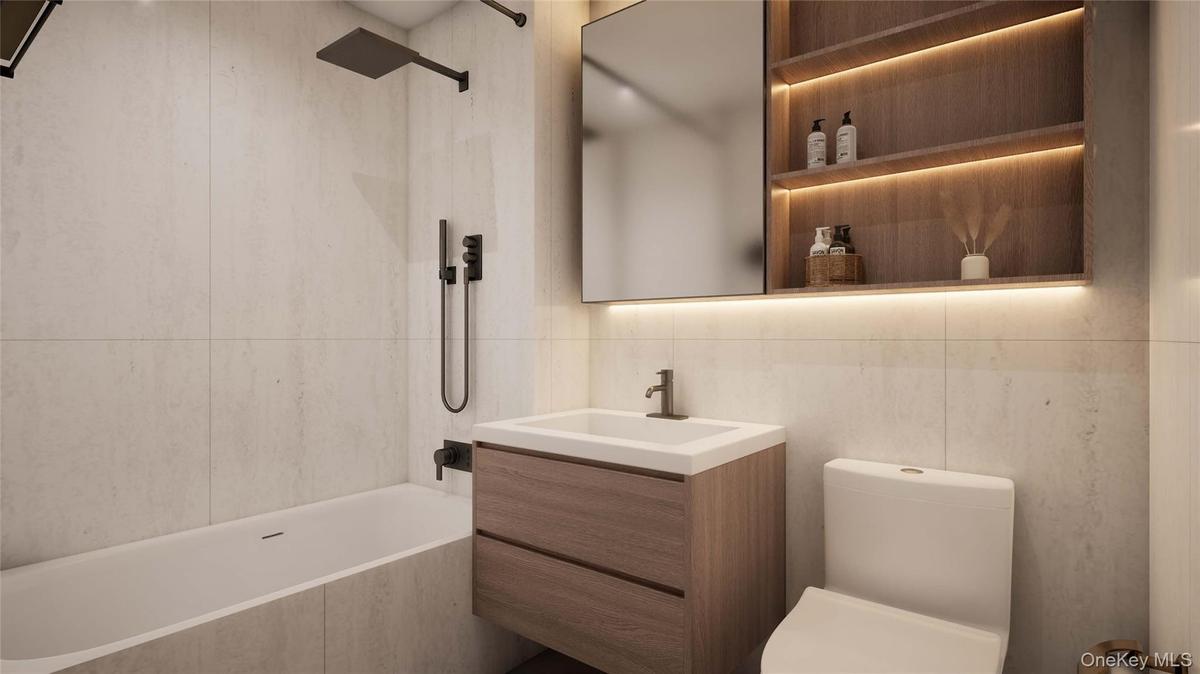 Bathroom with vanity, tiled shower / bath, and tile walls