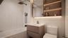 Bathroom with vanity, tiled shower / bath, and tile walls