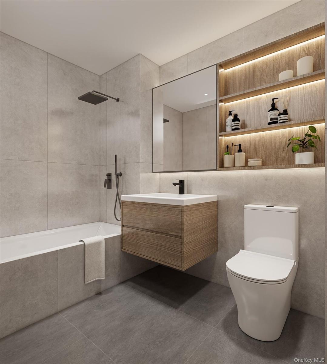 Bathroom featuring vanity, tiled shower / bath, and tile walls