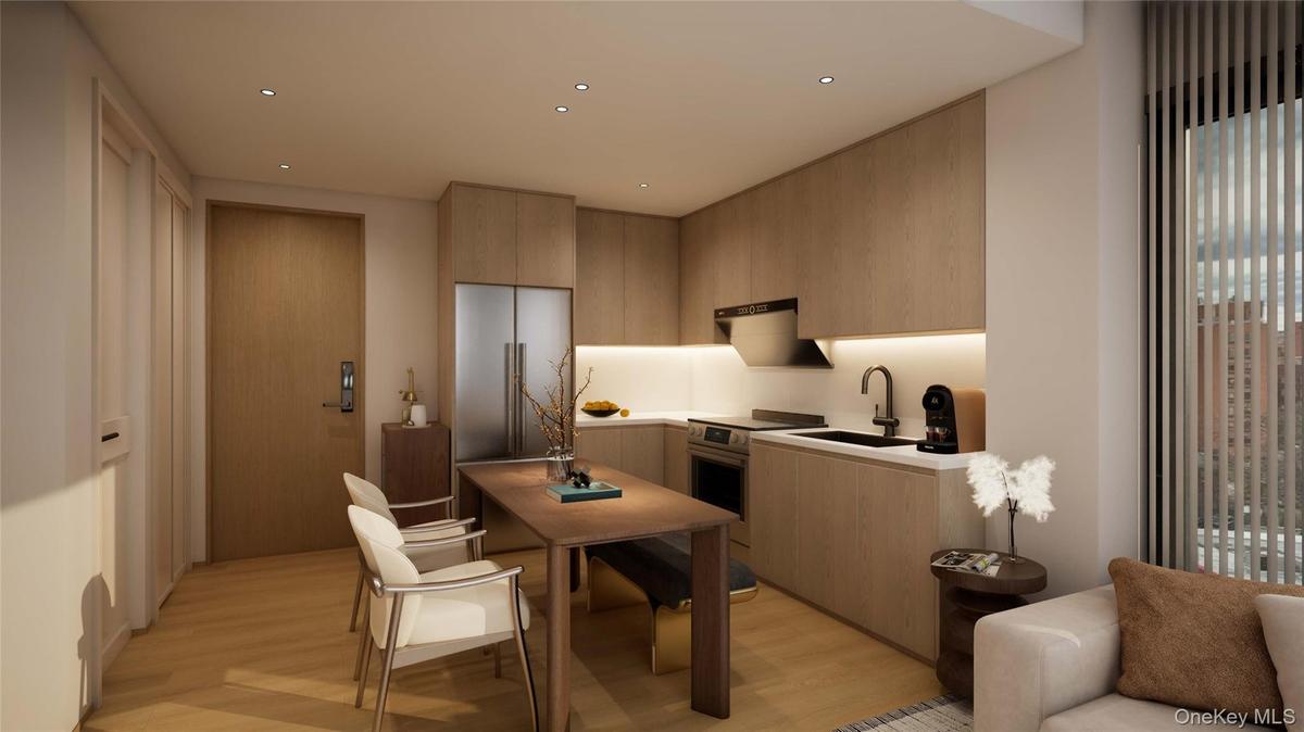 Kitchen featuring modern cabinets, light wood-type flooring, light brown cabinets, recessed lighting, and stainless steel oven