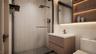 Bathroom featuring vanity, a walk in shower, and tile walls