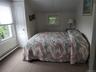 Bedroom with lofted ceiling, carpet floors, and ornamental molding
