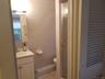Full bathroom with vanity, a stall shower, tile walls, and tile patterned floors