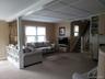 Carpeted living room with plenty of natural light and stairway