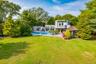 Modern architectural residence with a private swimming pool, expansive patio, and a dedicated gazebo