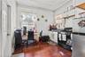 Kitchen featuring stainless steel appliances, white cabinetry, dark wood-style flooring, and crown molding