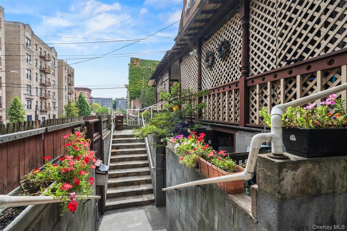 View of property exterior featuring stairs from street
