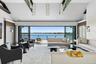 Living room with high vaulted ceiling, a water view, carpet floors, and recessed lighting