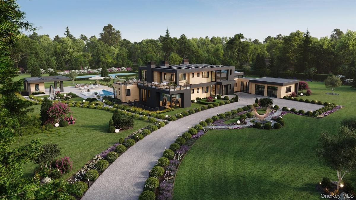 An expansive estate revealed from above, showcasing the home’s bold modern architecture, curated landscaping, and pool pavilion. The sweeping drive an