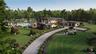 An expansive estate revealed from above, showcasing the home’s bold modern architecture, curated landscaping, and pool pavilion. The sweeping drive an