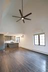 Unfurnished living room featuring baseboard heating, dark wood finished floors, and healthy amount of natural light