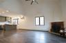 Unfurnished living room featuring baseboard heating, dark wood finished floors, and healthy amount of natural light