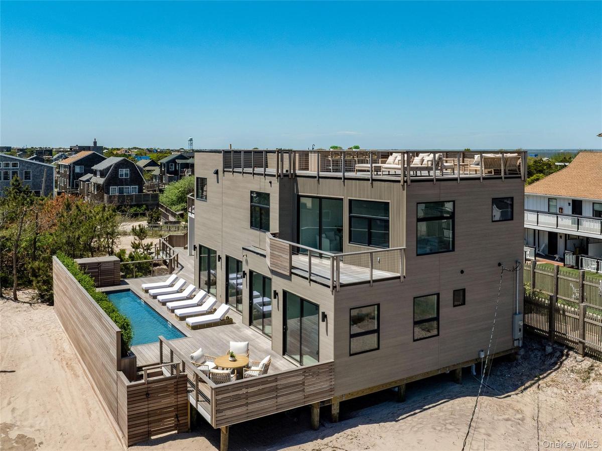 Rear view of property with a wooden deck, a residential view, and an outdoor pool