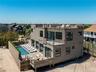 Rear view of property with a wooden deck, a residential view, and an outdoor pool
