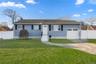 Ranch-style house featuring a gate, concrete driveway, and a garage