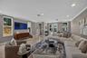 Open layout living room with additional card or dining table overlooking pool area.