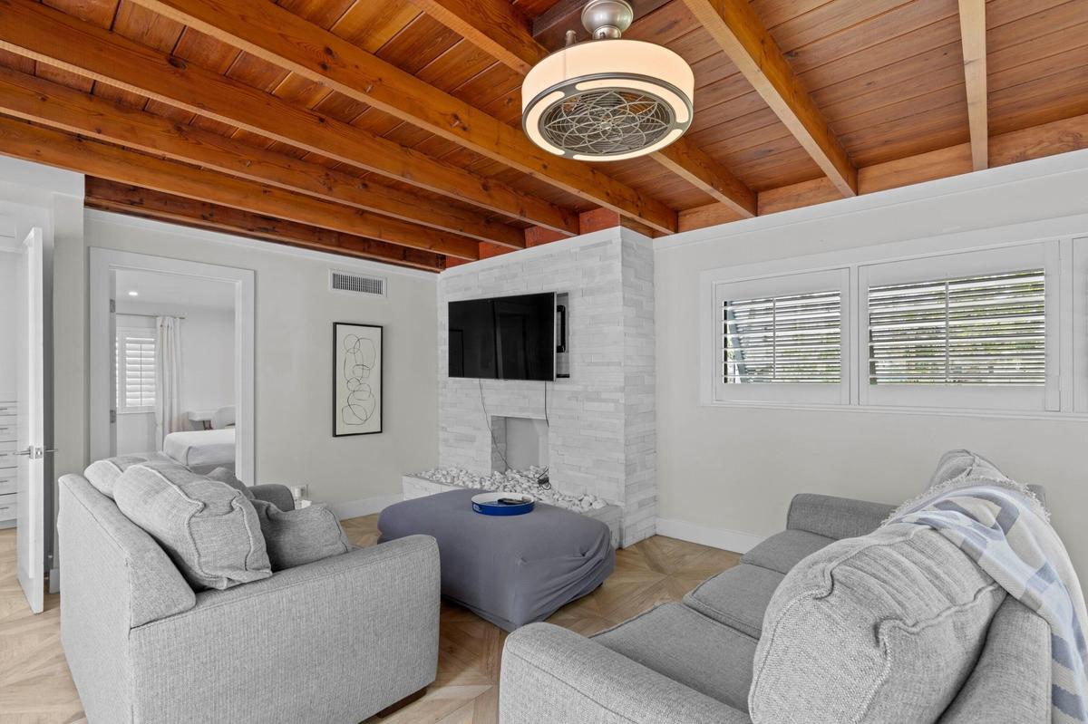 Living room with exposed beam ceilings.