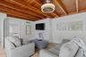 Living room with exposed beam ceilings.