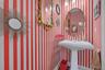 Bathroom with wallpapered walls and baseboards