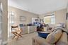 Home office with light colored carpet and baseboards