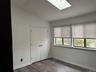 second bedroom on second floor with skylight and full bath