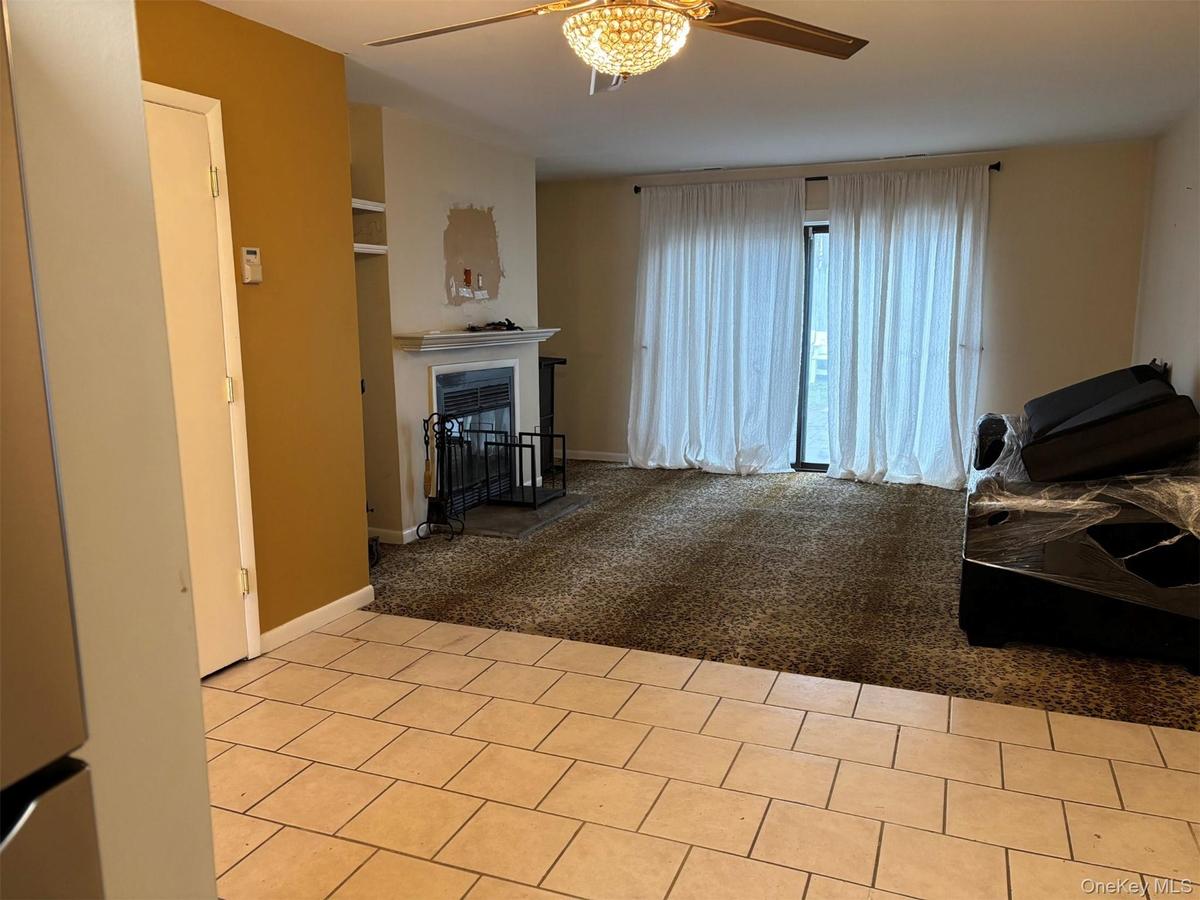 Dining/Living room with fireplace and sliding glass door out to patio