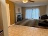 Dining/Living room with fireplace and sliding glass door out to patio