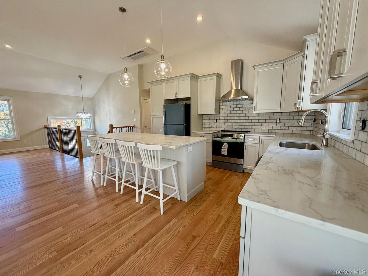 Pendant Lighting over Granite Island and Stainless Steel Appliances