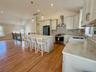 Pendant Lighting over Granite Island and Stainless Steel Appliances