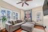 Living area with wood finished floors, ceiling fan, plenty of natural light, and recessed lighting