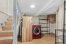 Laundry area with washer / dryer and light wood-style floors