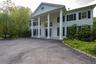 Neoclassical home featuring covered porch