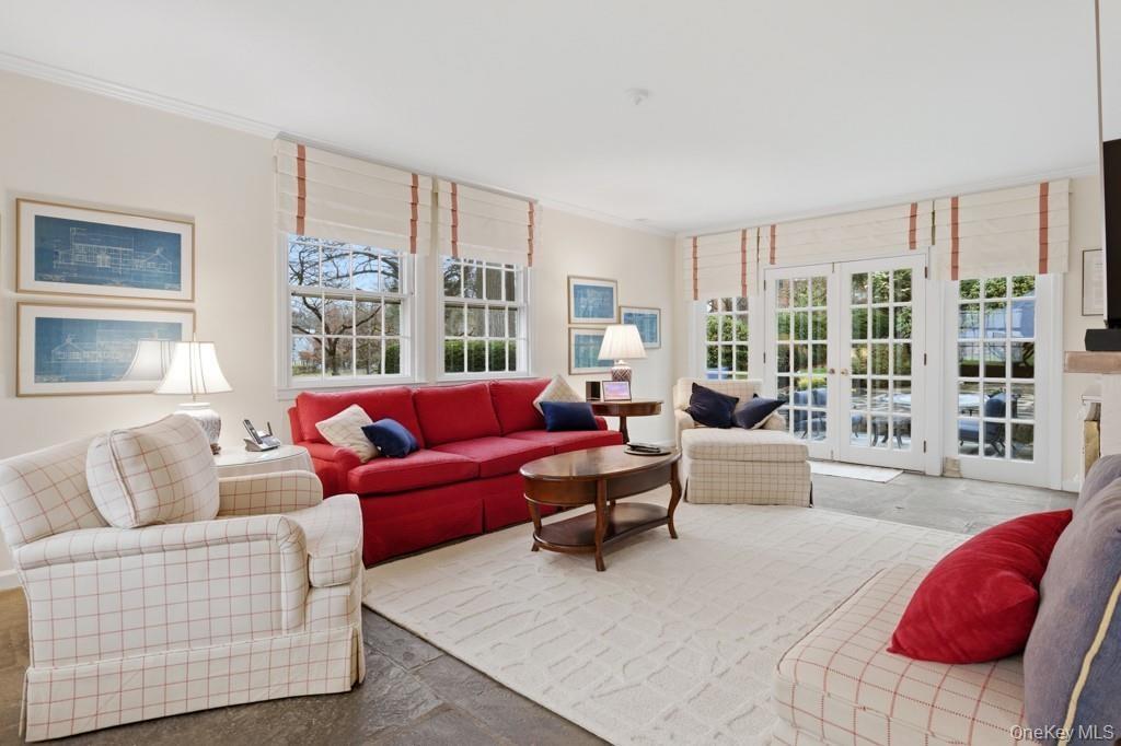 Family room featuring french doors to patio, and crown molding