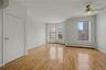 Unfurnished room with light wood-type flooring, baseboard heating, and a ceiling fan