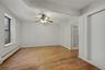 Spare room featuring baseboard heating, light wood finished floors, and ceiling fan