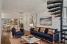 Living area featuring stairs, ornamental molding, wood finished floors, and a chandelier