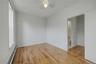 Empty room featuring baseboard heating, light wood-style flooring, and ceiling fan