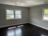 Spare room featuring dark wood-style flooring