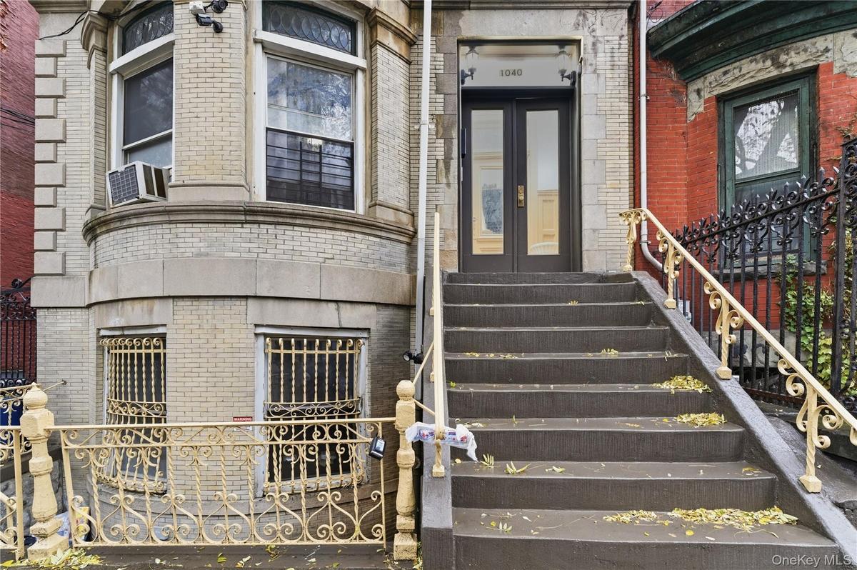 View of exterior entry featuring brick siding