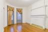 Unfurnished living room featuring light wood finished floors, a textured ceiling, and ornamental molding