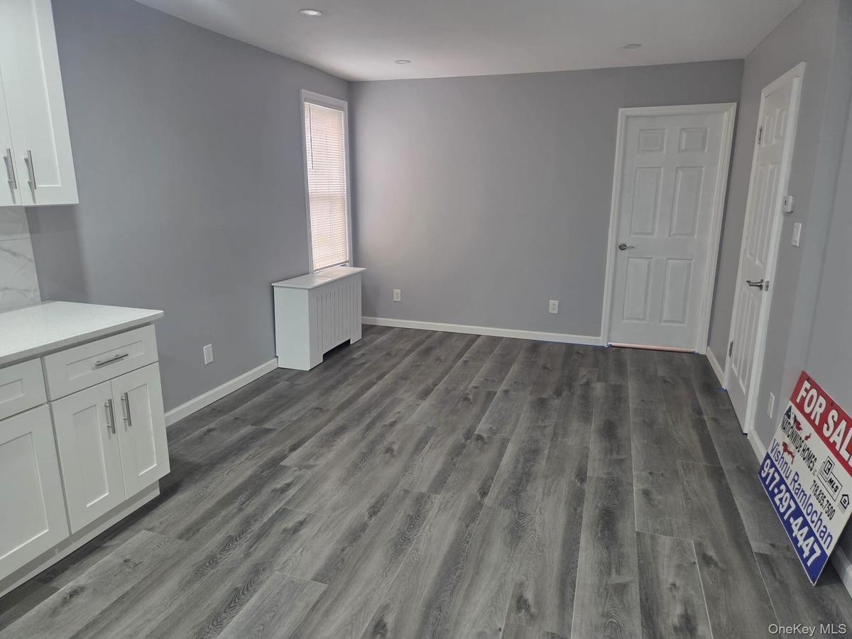 First Floor Unfurnished dining area featuring radiator and dark wood-style flooring