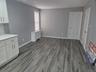 First Floor Unfurnished dining area featuring radiator and dark wood-style flooring