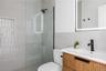 Full bath with vanity, a walk in shower, and tile walls